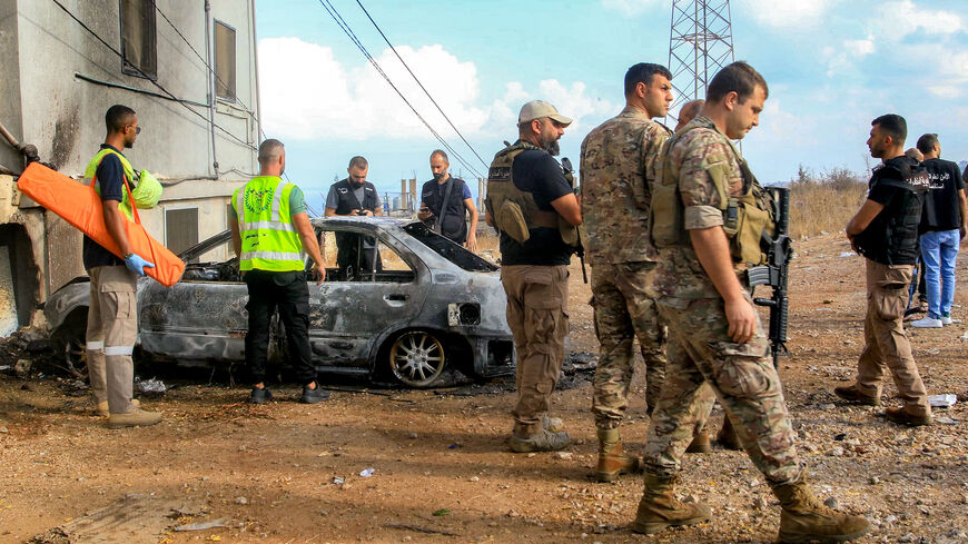 Lebanese army soldiers and security forces deploy near a vehicle that was hit by a reported drone-strike at the entrance of the village of Barja, about 30 kilometres south of Beirut, on Sept. 9, 2025. 