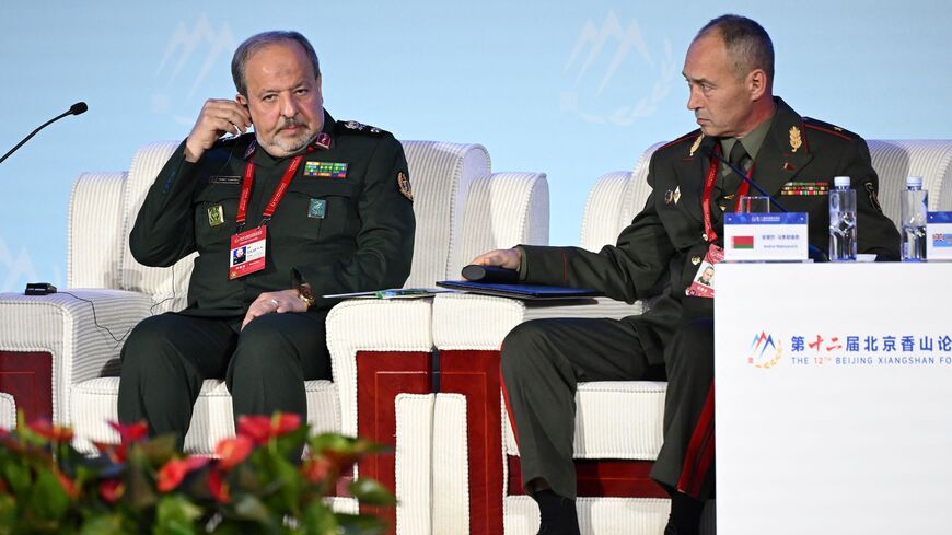 Iran's Deputy Defense Minister Majid Ebnoreza (L) sits next to Andrei Matsiyevich.