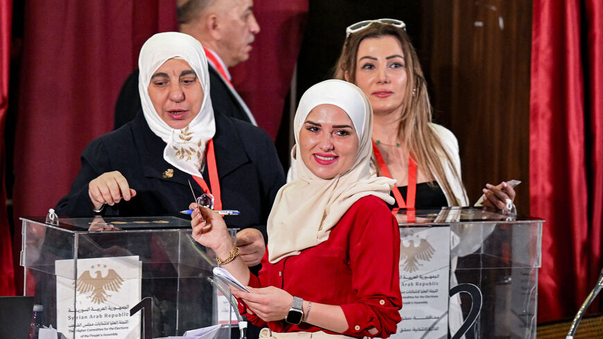A member of Syria's local committees votes in the country's selection process to designate an interim parliament, in Damascus on Oct. 5, 2025. 