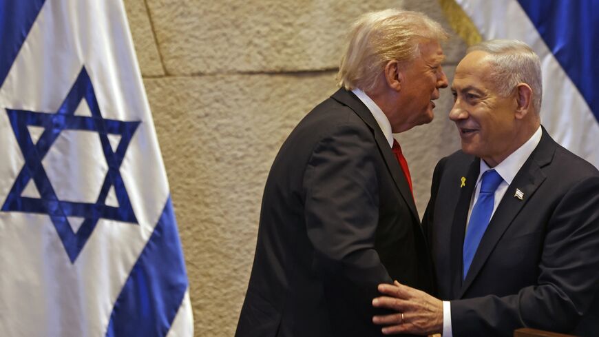 US President Donald Trump speaks with Israel's Prime Minister Benjamin Netanyahu in the Knesset, Israel's parliament, on Oct. 13, 2025, in Jerusalem. 