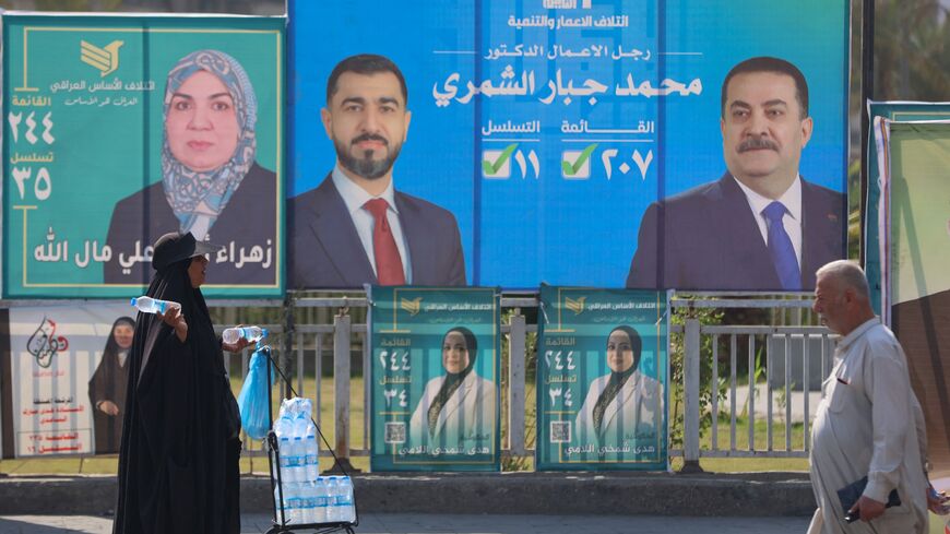 A woman walks past electoral billboards in central Baghdad on Oct. 19, 2025, ahead of parliamentary elections in Iraq on Nov. 11.