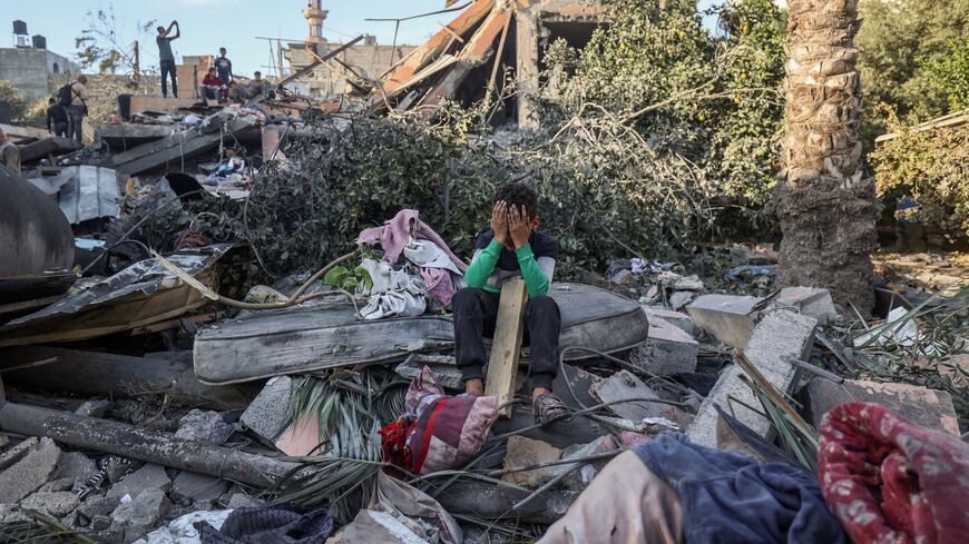 A boy reacts sitting amid the rubble of a house destroyed in an Israeli strike in Nuseirat, in the central Gaza Strip, on Oct. 29, 2025. 