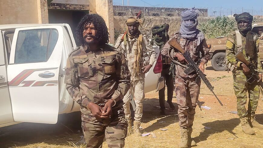 A photo released by the RSF purportedly shows its members detaining a fighter known as Abu Lulu (L) who was seen in execution videos from El-Fasher