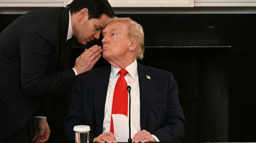 US Secretary of State Marco Rubio whispers in the ear of President Donald Trump during a roundtable about Antifa in the State Dining Room of the White House 