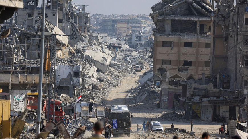 Palestinians gather as Red Cross personnel work in an area within the so-called "yellow line" to which Israeli troops withdrew under the ceasefire, as Hamas says it continues to search for the bodies of deceased hostages seized during the October 7, 2023, attack on Israel, in Gaza City November 2, 2025. REUTERS/Dawoud Abu Alkas