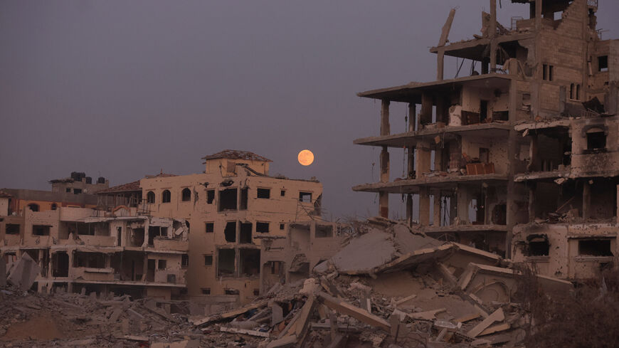 The Beaver Moon supermoon rises above destroyed buildings amid a ceasefire between Israel and Hamas, in Gaza City, November 5, 2025. REUTERS/Dawoud Abu Alkas