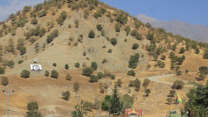 A portrait of jailed Kurdistan Workers Party (PKK) leader Abdullah Ocalan and a sign with the words "Serok Apo," are displayed on a hillside in the Qandil mountains, Iraq, October 26, 2025. REUTERS/Thaier Al-Sudani