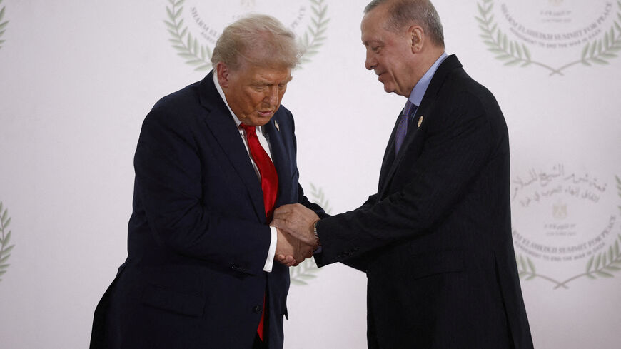 FILE PHOTO: U.S. President Donald Trump and Turkish President Tayyip Erdogan shake hands as they pose for a photo, at a world leaders' summit on ending the Gaza war, amid a U.S.-brokered prisoner-hostage swap and ceasefire deal between Israel and Hamas, in Sharm el-Sheikh, Egypt, October 13, 2025. Yoan Valat/Pool via REUTERS/File Photo