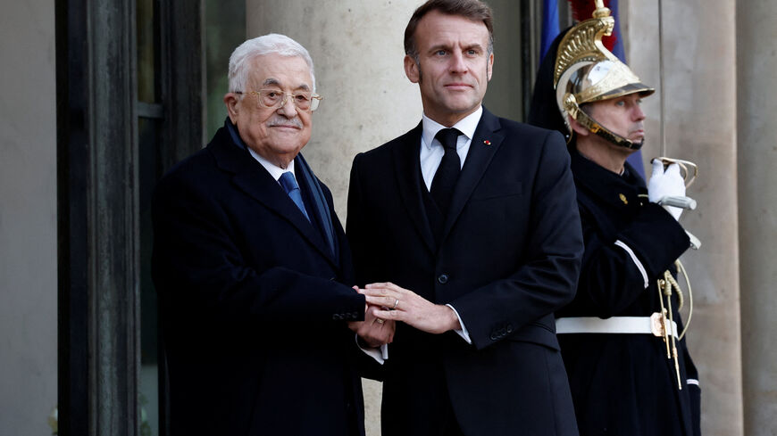 French President Emmanuel Macron welcomes Palestinian President Mahmoud Abbas at the Elysee Palace in Paris, France November 11, 2025. REUTERS/Benoit Tessier