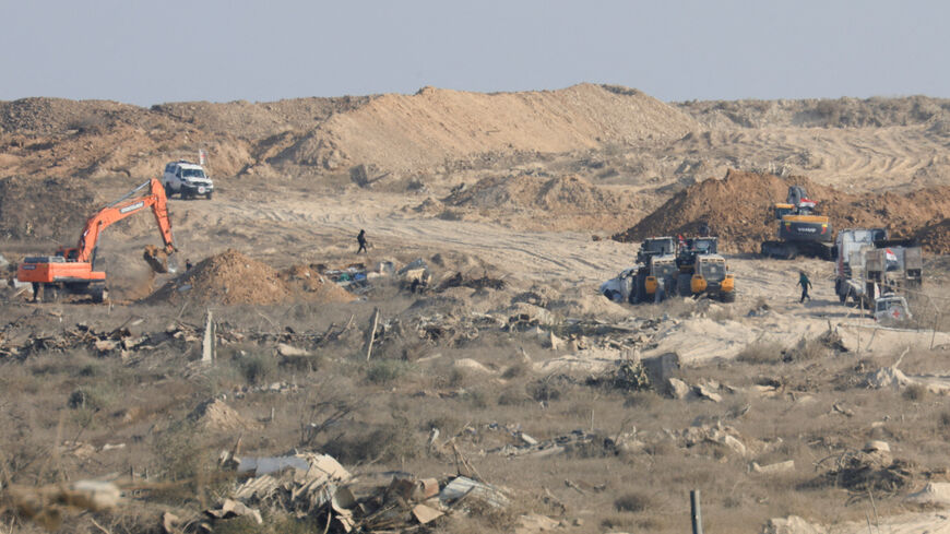 A machinery operates next to a Red Cross vehicle at an area within the so-called "yellow line" to which Israeli troops withdrew under the ceasefire, as Hamas says it continues to search for the bodies of deceased hostages seized during the October 7, 2023, attack on Israel, in Gaza City November 12, 2025. REUTERS/Dawoud Abu Alkas