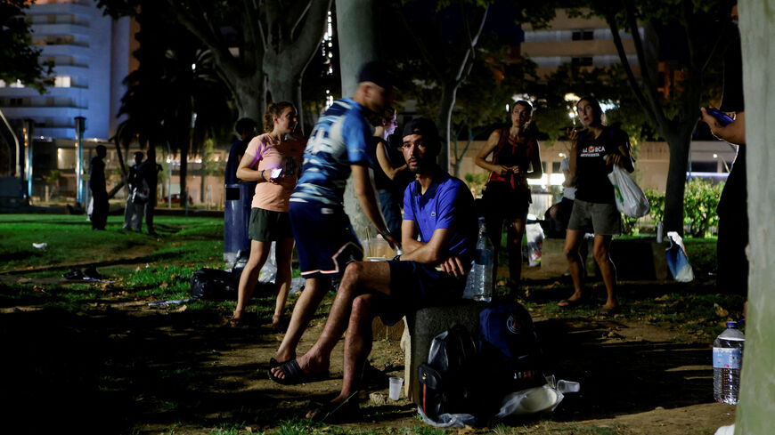An Algerian migrant sits in a public park after arriving from Algeria earlier in the day, as more than 30 boats carrying about 600 irregular migrants have reached the Balearic Islands since Monday, according to officials, in Palma de Mallorca, Spain, August 12, 2025. REUTERS/Francisco Ubilla