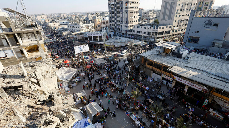 FILE PHOTO: People gather and shop at a local market, in Nuseirat, central Gaza Strip, October 28, 2025. REUTERS/Mahmoud Issa/File Photo