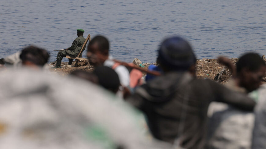 An M23 rebel sits at the quay in front of the Kituku market in Goma, which is controlled by M23 rebels, in North Kivu province of the Democratic Republic of Congo March 21, 2025. REUTERS/Zohra Bensemra