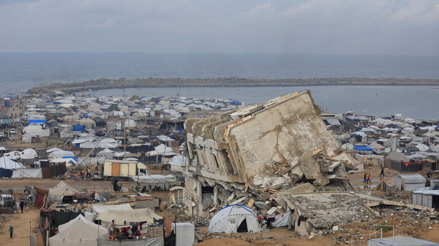 Palestinian-tent shelter amid rubble, along the coast on a rainy day, during a ceasefire between Israel and Hamas, in Gaza City, November 14, 2025. REUTERS/Dawoud Abu Alkas