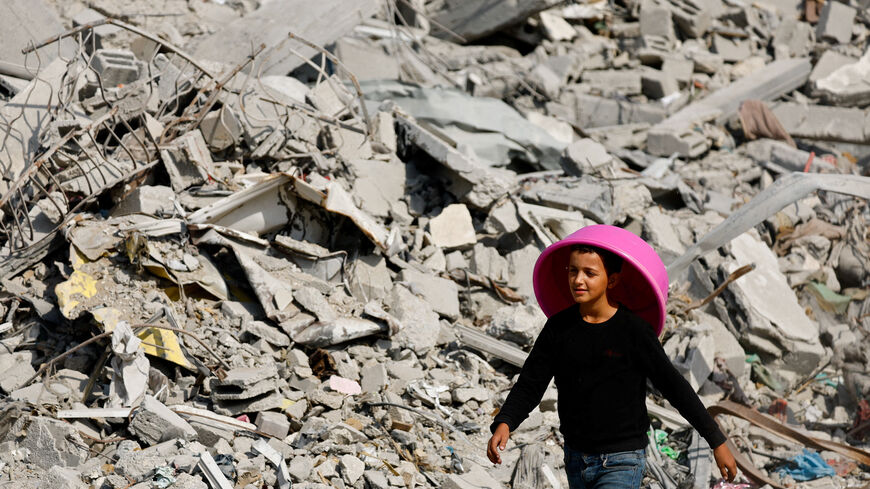 A Palestinian youth walks past the rubble of destroyed buildings, amid a ceasefire between Israel and Hamas, in Gaza City, November 2, 2025. REUTERS/Mahmoud Issa