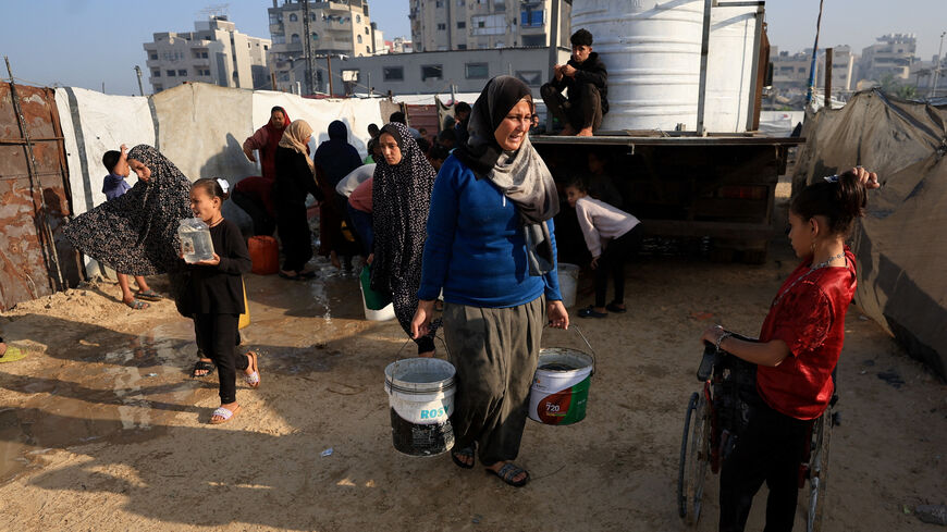 Palestinians gather to collect water, amid a ceasefire between Israel and Hamas, in Gaza City, November 19, 2025. REUTERS/Dawoud Abu Alkas