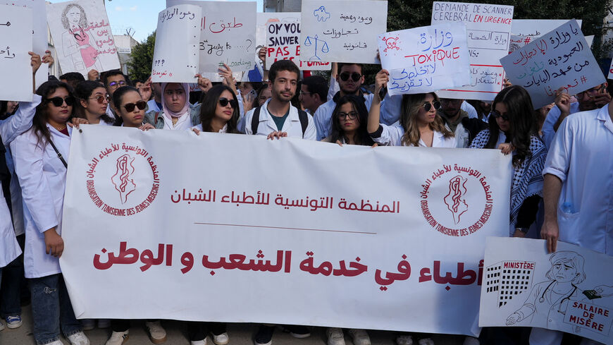 Young doctors gather and hold signs during a protest as thousands went on strike across Tunisia on Wednesday, demanding higher pay and warning of an impending collapse of the health system, part of a broader wave of social unrest convulsing the country, in Tunis, Tunisia, November 19, 2025. REUTERS/Jihed Abidellaoui