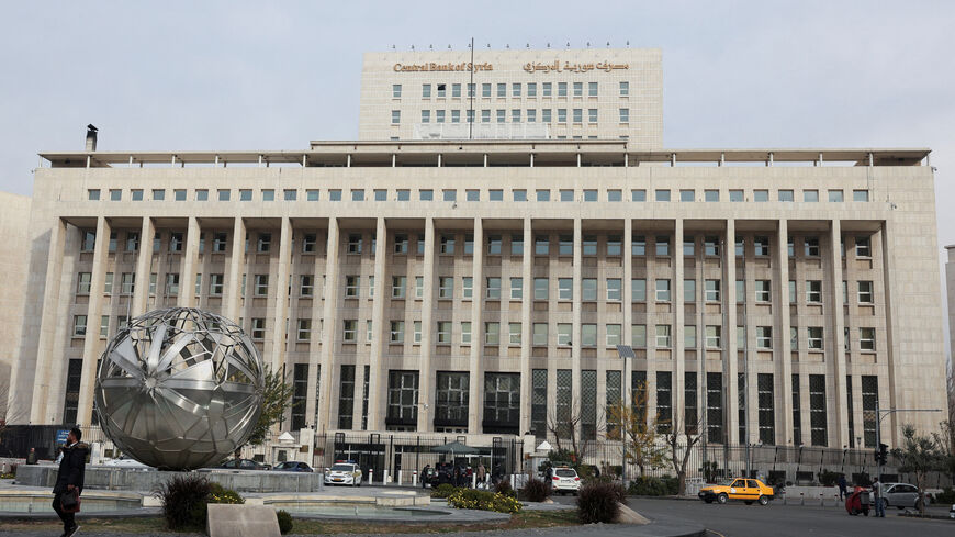 People and cars are seen in front of the Central Bank of Syria in Damascus, Syria December 11, 2024. REUTERS/Amr Abdallah Dalsh