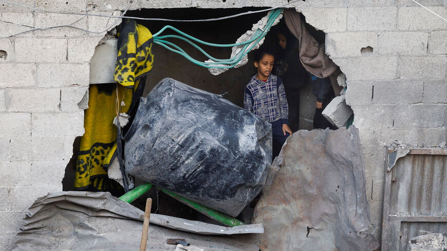 Palestinians inspect the site of Saturday's Israeli strike in the Central Gaza Strip, November 23, 2025. REUTERS/Mahmoud Issa