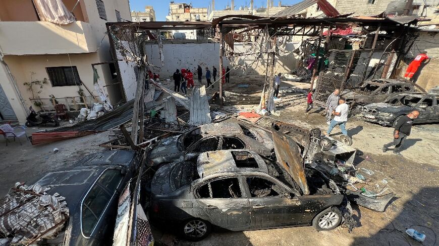 People inspect the damage in the aftermath of an Israeli strike on the Ain al-Helweh camp for Palestinian refugees in southern Lebanon