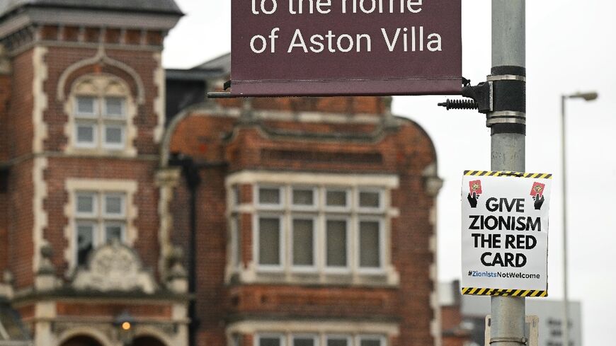 A poster that reads 'Give Zionism the red card' is seen on a lamp post near Villa Park in Birmingham ahead of the Europa League match between Maccabi Tel Aviv and Aston Villa