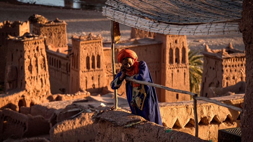 A man stands atop the kasbah of Ait-Ben-Haddou.