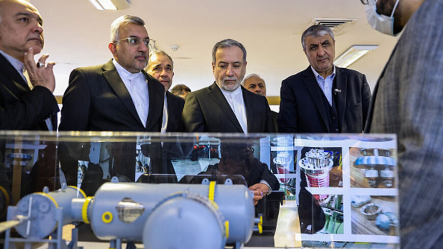 In this handout photo released by the Atomic Energy Organization of Iran (AEOI) on November 10, 2025, Iran's Foreign Minister Abbas Araqchi (L) is accompanied by AEOI chief Mohammad Eslami during a visit to a facility in Tehran. (Photo by Atomic Energy Organization of Iran / AFP)