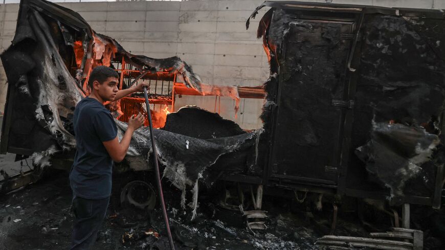 A Palestinian man tries to extinguish flames from a burning truck after an Israeli settlers attack in the village of Beit Lid, east of Tulkarm, in the occupied West Bank on Nov. 11, 2025.