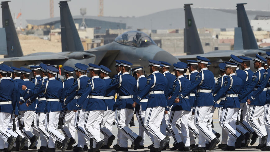 Newly graduated Saudi air force officers march in front of F-15 fighter jets during a ceremony marking the 50th anniversary of the creation of the King Faisal Air Academy at King Salman airbase in Riyadh on January 25, 2017. / AFP / FAYEZ NURELDINE (Photo credit should read FAYEZ NURELDINE/AFP via Getty Images)