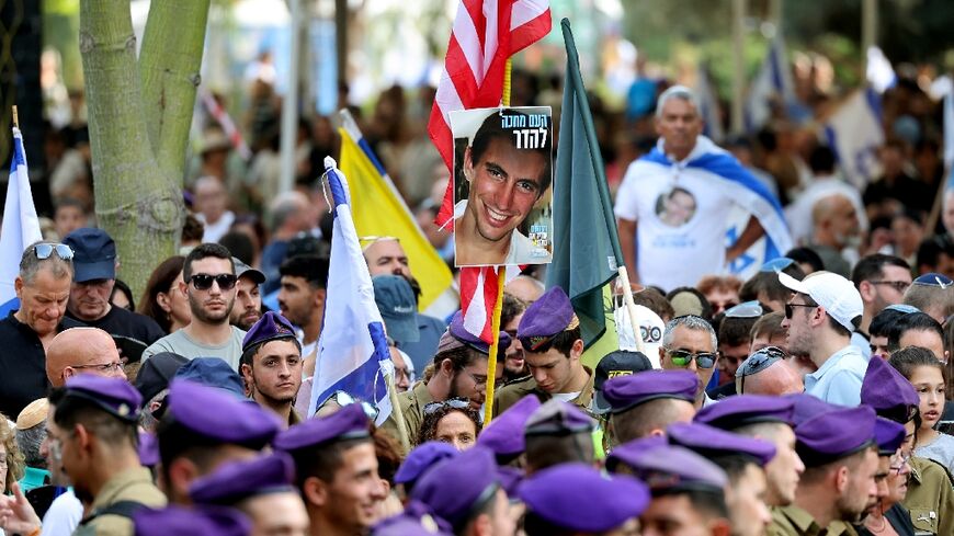 Mourners carry a portrait of Hadar Goldin, killed in combat in Gaza in 2014, during his funeral Tuesday after his remains were returned by Hamas