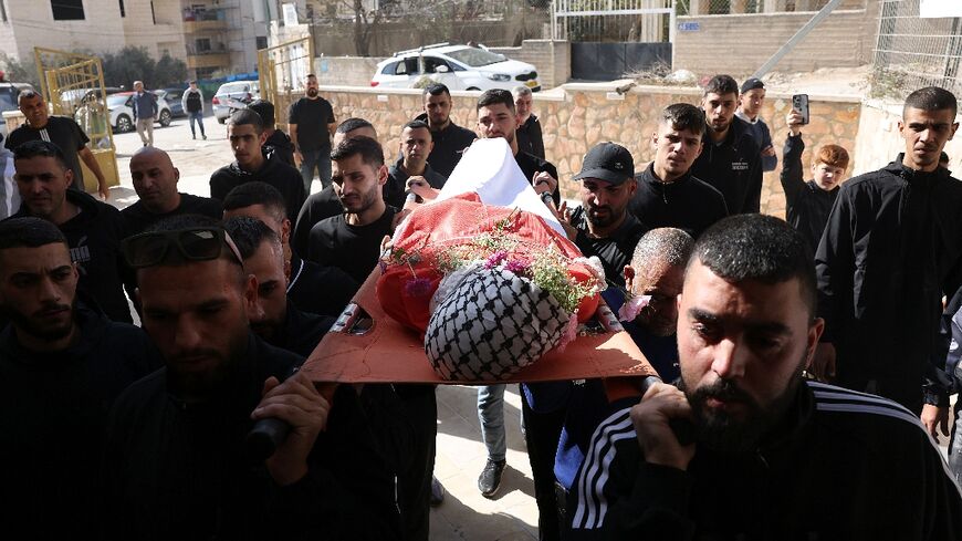 Mourners carry the body of 16-year-old Palestinian Sami Mashayekh during his funeral
