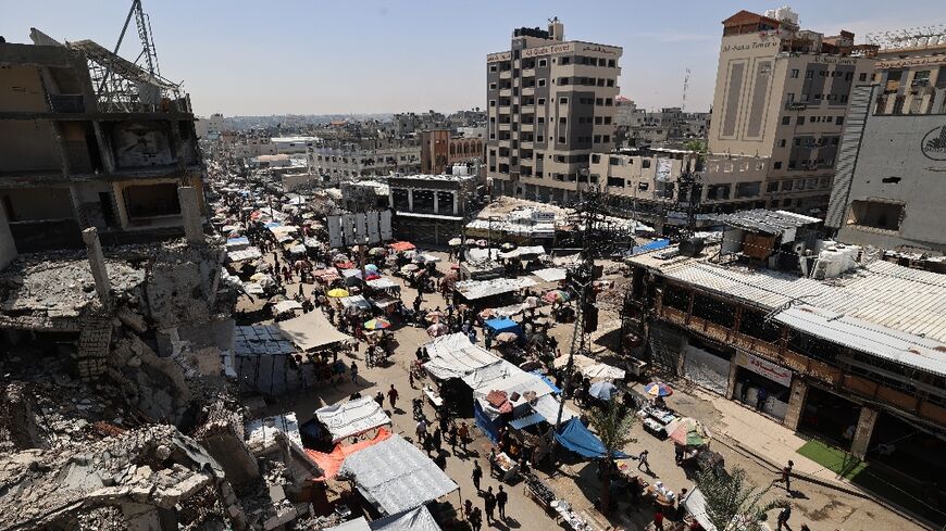 Palestinians gather at a market at the Nuseirat refugee camp in the central Gaza Strip