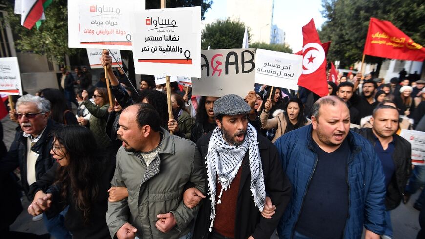 Tunisians shout slogans against the president during a demonstration organised by NGOs and political parties demanding the release of political prisoners and greater freedom of expression in Tunis