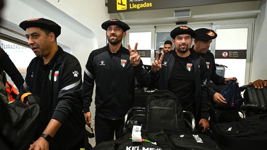 Palestinian national football team members wear the traditional Basque "txapela" (beret) as they arrive at Bilbao airport ahead of a match against the Basque national team