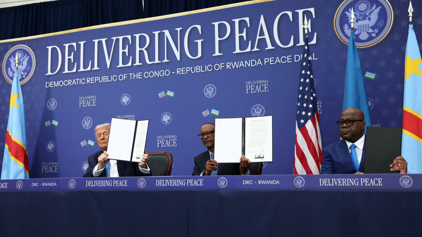 U.S. President Donald Trump, President of the Democratic Republic of the Congo Felix Tshisekedi and President of Rwanda Paul Kagame hold a signed document during a signing ceremony at the U.S. Institute of Peace in Washington, D.C., U.S., December 4, 2025. REUTERS/Kevin Lamarque