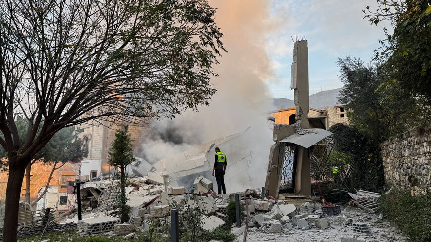 A civil defence member stands on rubble at a damaged site after Israel's military said it struck targets in two southern Lebanese towns on Thursday, in Jbaa southern Lebanon, December 4, 2025. REUTERS/Ali Hankir