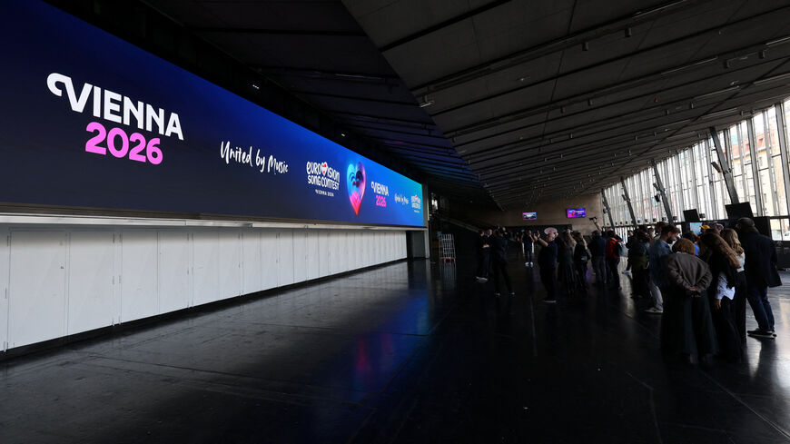 Journalists stand in front of a screen in Wiener Stadthalle, the venue of next year's Eurovision in Vienna, Austria, November 18, 2025. REUTERS/Leonhard Foeger