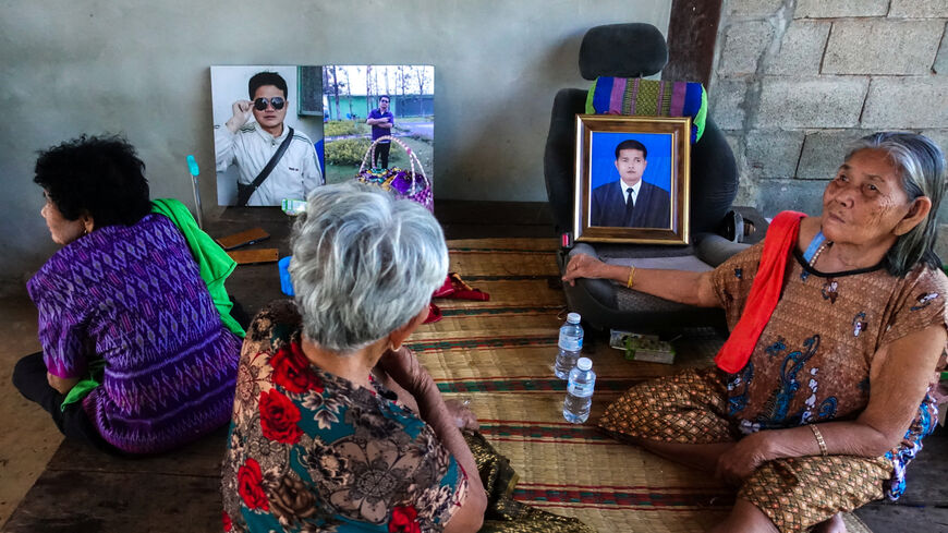 On Rinthalak, 80, mother and relatives of deceased Thai hostage Sudthisak Rinthalak, who was kidnapped to Gaza in the deadly October 7, 2023, attack by Hamas, sit next to his pictures at their house in Nong Khai province, Thailand, December 5, 2025. REUTERS/Thomas Suen