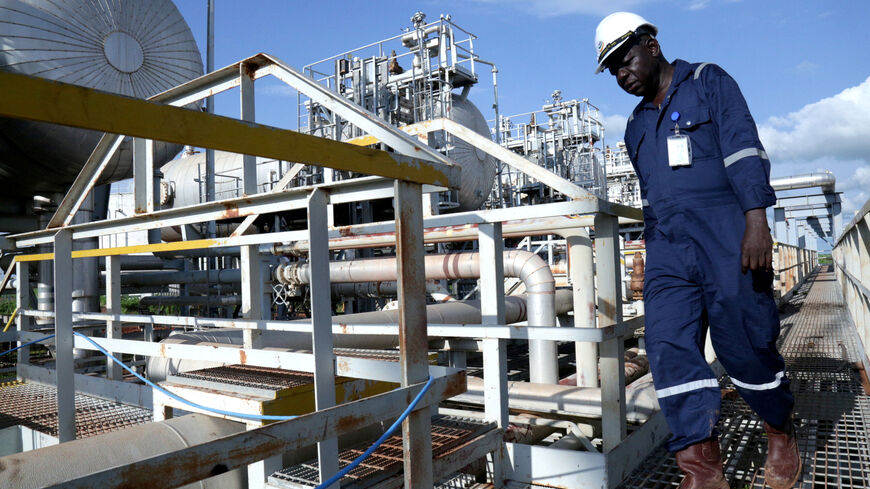 FILE PHOTO: A worker walks by an oil well at the Toma South oil field to Heglig, in Ruweng State, South Sudan August 25, 2018. Picture taken August 25, 2018. REUTERS/Jok Solomun/File Photo