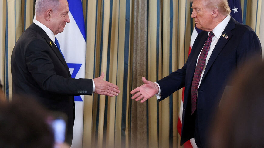 FILE PHOTO: U.S. President Donald Trump and Israeli Prime Minister Benjamin Netanyahu reach to shake hands at a joint press conference in the State Dining Room at the White House in Washington, D.C., U.S., September 29, 2025. REUTERS/Jonathan Ernst/ File Photo