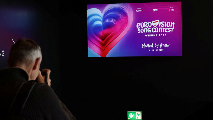 FILE PHOTO: A photographer takes a picture of a TV screen in Wiener Stadthalle, the venue of next year's Eurovision in Vienna, Austria, November 18, 2025. REUTERS/Leonhard Foeger/File Photo