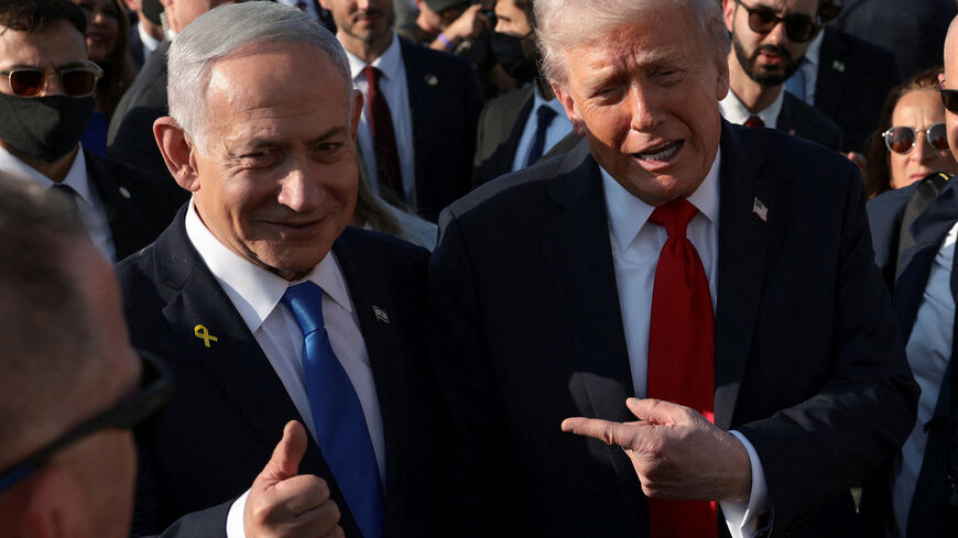 FILE PHOTO: U.S. President Donald Trump  gestures next to Israeli Prime Minister Benjamin Netanyahu at Ben Gurion International Airport in Lod, Israel, October 13, 2025. REUTERS/Evelyn Hockstein/File Photo