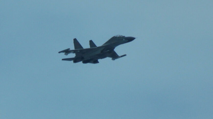 FILE PHOTO: An aerial view of a Chinese fighter jet flying close to a Philippine Coast Guard aircraft carrying journalists during a patrol flight, days after two Chinese vessels collided in the area while allegedly trying to block a Philippine supply mission, over the disputed Scarborough Shoal in the South China Sea, August 13, 2025. REUTERS/Adrian Portugal/File Photo