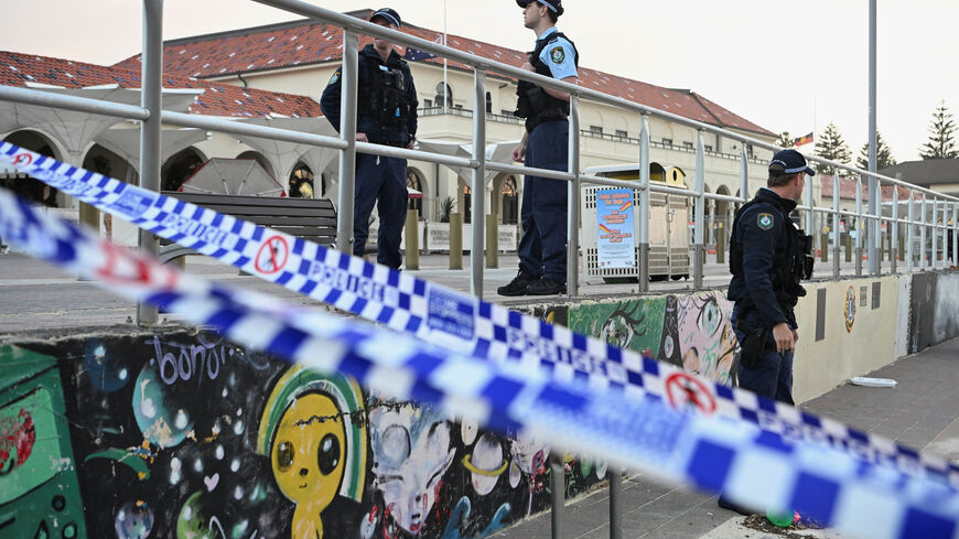Police officers stand guard following the attack on a Jewish holiday celebration at Sydney's Bondi Beach, in Sydney, Australia, December 15, 2025. REUTERS/Flavio Brancaleone