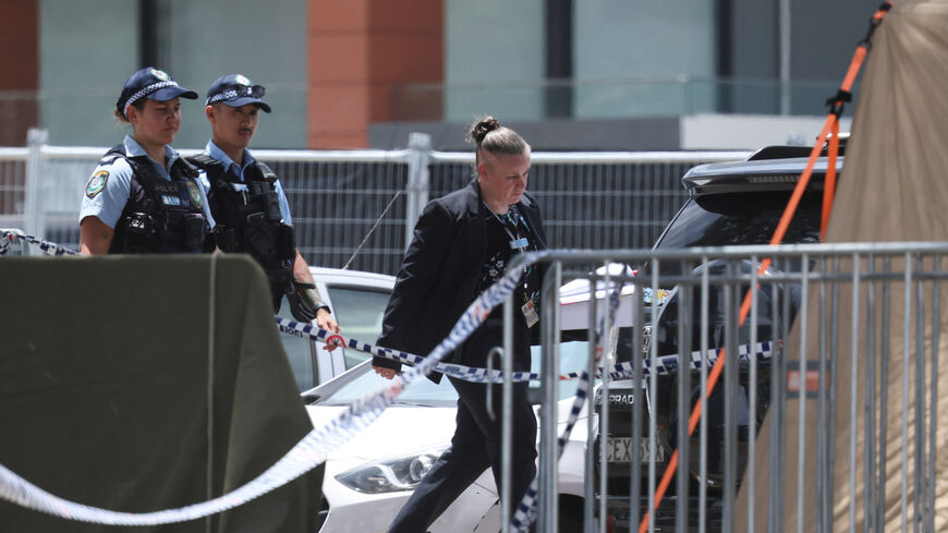 Police officers enter a tent at the scene of a shooting during a Jewish holiday celebration at Bondi Beach, in Sydney, Australia, December 15, 2025. REUTERS/Hollie Adams/File Photo