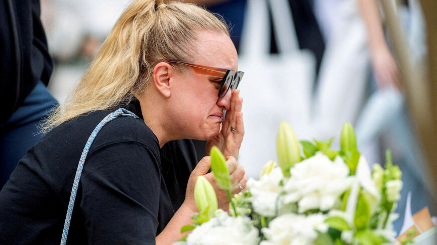 FILE PHOTO: A woman grieves at a floral memorial in honour of the victims of the mass shooting targeting a Hanukkah celebration on Sunday, at Bondi Beach, in Sydney, Australia, December 16, 2025. REUTERS/Jeremy Piper/File Photo
