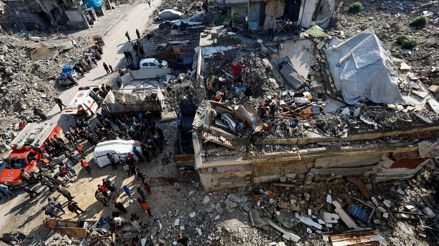 People gather during a search and rescue operation at the site of a house that was partially destroyed during the war and collapsed on Tuesday, at Shati refugee camp in Gaza City, December 16, 2025. REUTERS/Mahmoud Issa