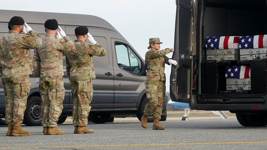 Members of the military salute during a dignified transfer of the remains of two Iowa National Guard members killed in Syria, Sgt. Edgar Torres Tovar and Sgt. William Howard, and Ayad Mansoor Sakat, of Macomb, Michigan, who was working as an interpreter in Syria, at Dover Air Force Base in Dover, Delaware, U.S., December, 17, 2025. REUTERS/Nathan Howard