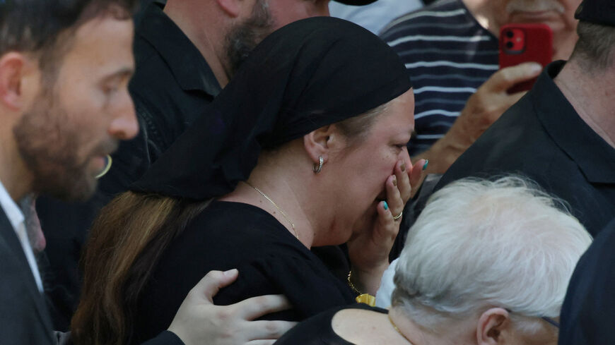 The mother of Matilda, 10, who was killed during the mass shooting at Bondi beach on Sunday, leaves her funeral in Sydney, Australia, December 18, 2025. REUTERS/Hollie Adams