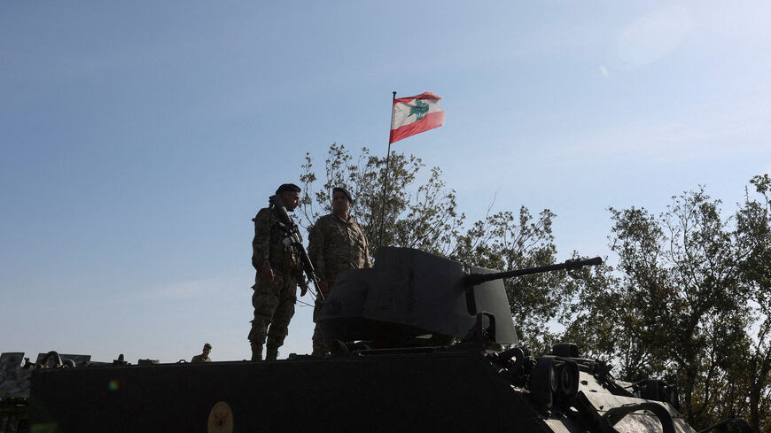 FILE PHOTO: Lebanese army members stand on a military vehicle during a Lebanese army media tour, to review the army's operations in the southern Litani sector, in Alma Al-Shaab, near the border with Israel, southern Lebanon, November 28, 2025. REUTERS/Aziz Taher/File Photo